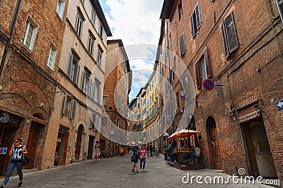 SIENA, ITALY â€“ MAY 25, 2017: Medieval narrow street in Siena, Tuscany, Italy. Editorial Stock Photo